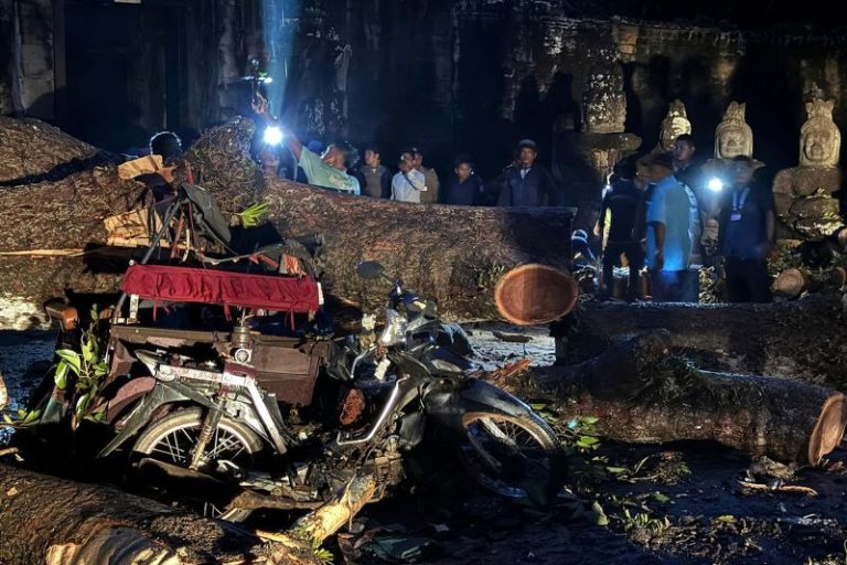 Fierce storm topples tree at Cambodian Angkor temple complex, killing 1 and damaging statues